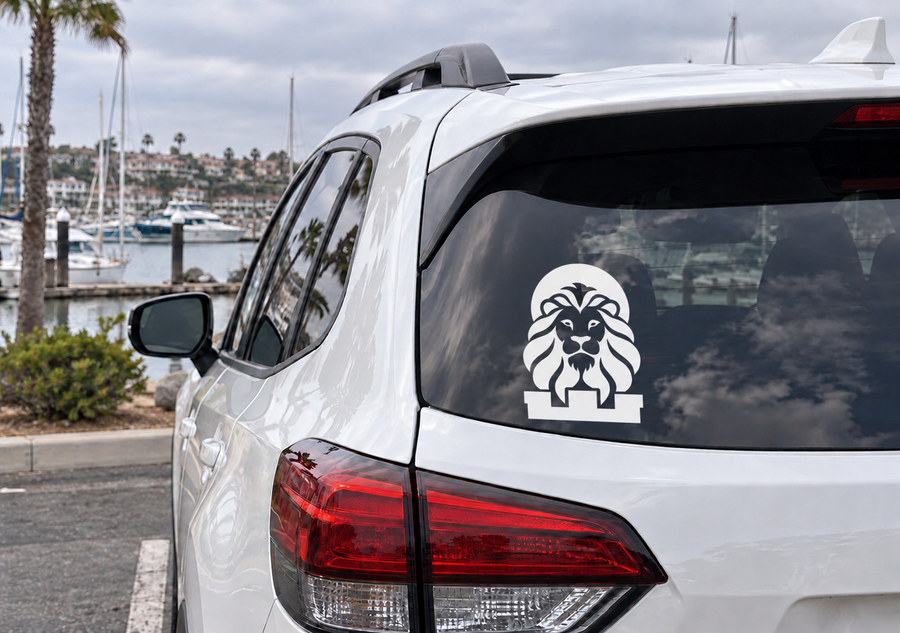 Lion battlement crest vinyl decal on car rear window, white emblem