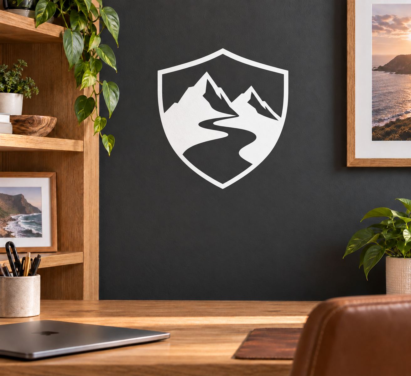 Vinyl shield decal with white outline and black-and-white mountain landscape graphic