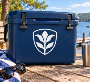Shield-shaped vinyl decal with black lily emblem on a dark blue surface