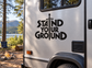 Stand Your Ground vinyl decal with bold black lettering on vehicle side
