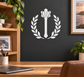 Vinyl wall decal of laurel wreath with central medieval mace silhouette