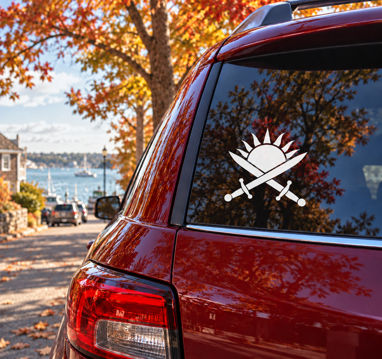 Car vinyl decal of a crossed swords-and-sunrise emblem on the rear window