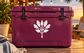 White oak tree and spear crown vinyl decal on maroon surface