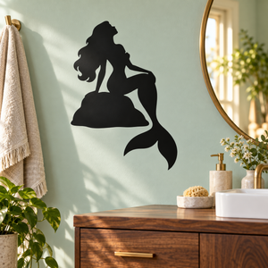 Black seated mermaid vinyl decal on wall, rock base with long flowing tail