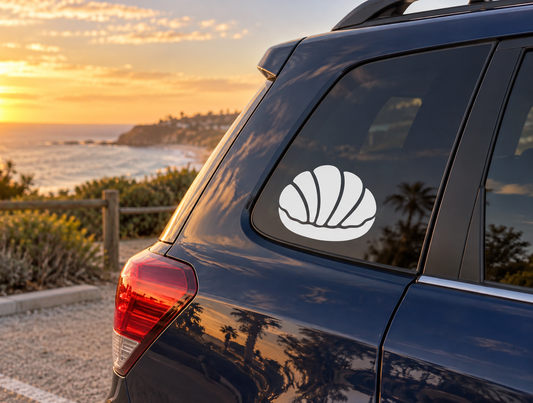 Concha sweet bread vinyl decal, white shell icon on a dark car window