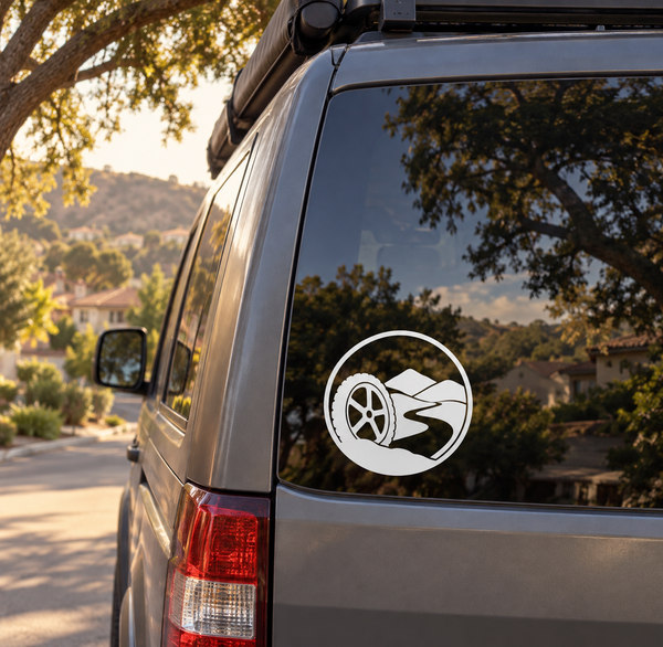 Bicycle crest vinyl decal on car rear window, white circular logo with bike silhouette
