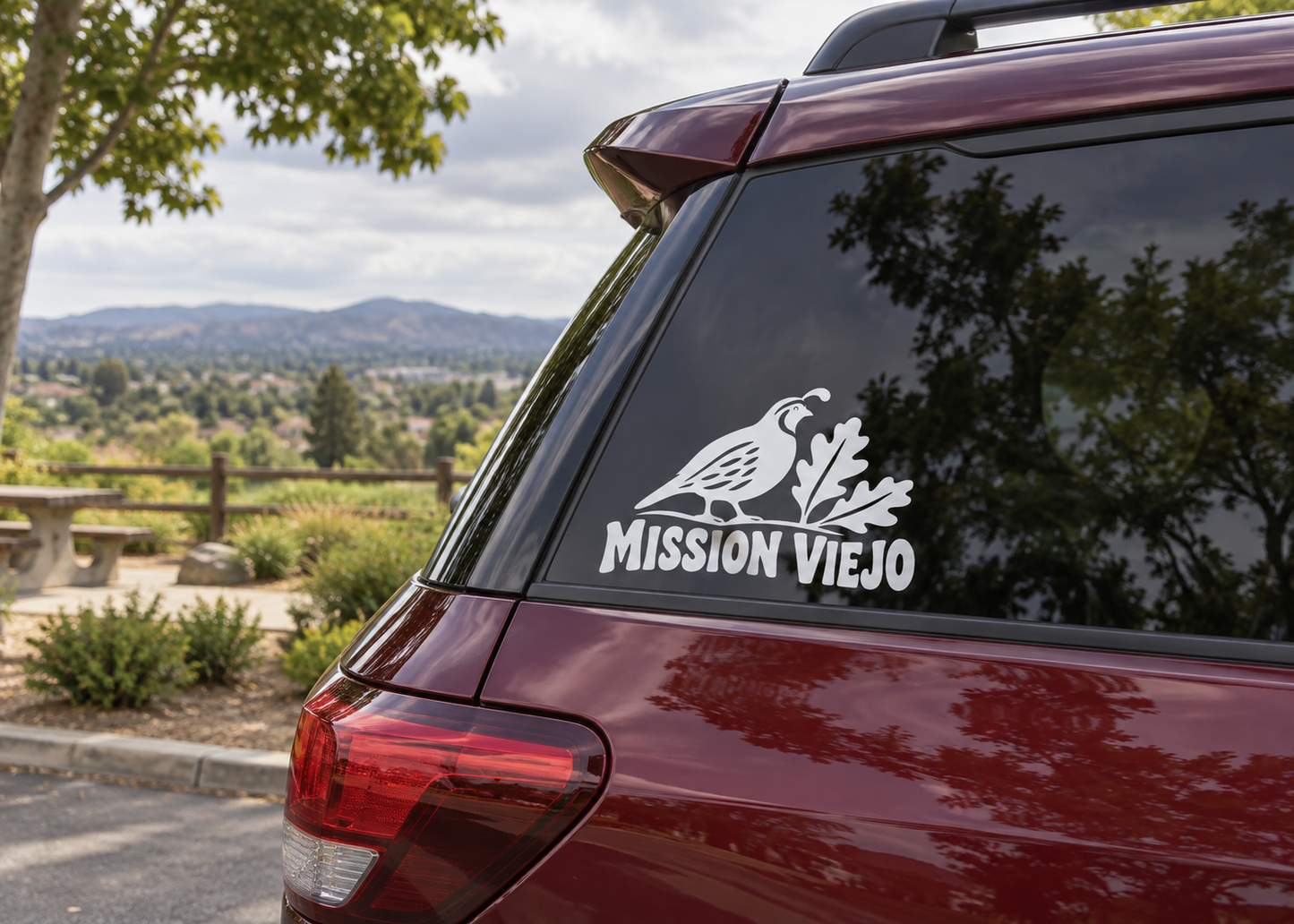 Vinyl decal of quail and Mission Viejo wordmark on car rear window
