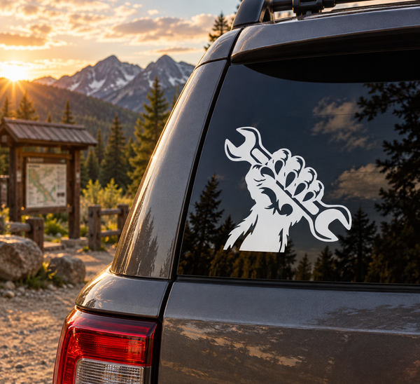 Monster hand wrench vinyl decal: white monster holding a wrench on a dark surface.