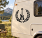 Black vinyl decal of a bass guitar with open laurel wreath on an RV side panel