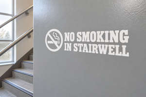 No smoking in stairwell vinyl decal with crossed cigarette icon and bold light lettering