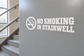 No smoking in stairwell vinyl decal with crossed cigarette icon and bold light lettering