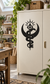 Black occult snake symbol vinyl decal on a light cabinet door
