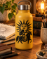 Tarot sun emblem vinyl decal on a yellow bottle, black illustrated sun figure design