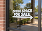 White "OFFICE SPACE FOR SALE" directional vinyl decal with right-pointing arrow on window