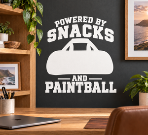Black-and-white paintball vinyl decal reading “POWERED BY SNACKS AND PAINTBALL”