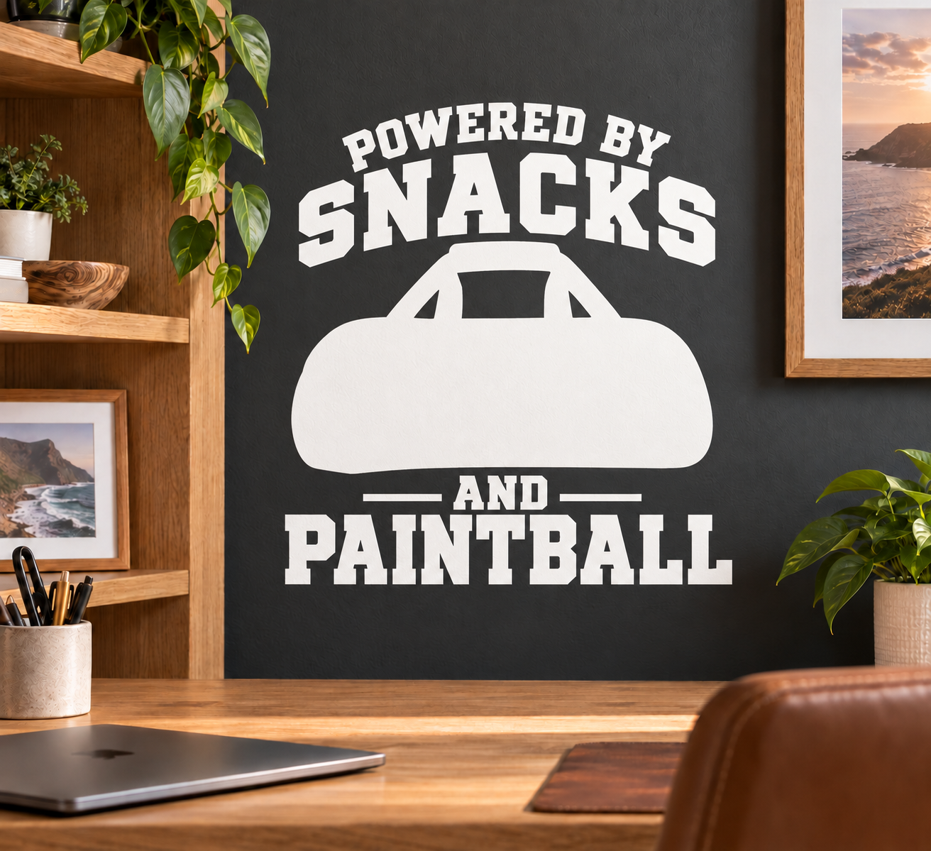 Black-and-white paintball vinyl decal reading “POWERED BY SNACKS AND PAINTBALL”