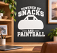 Black-and-white paintball vinyl decal reading “POWERED BY SNACKS AND PAINTBALL”