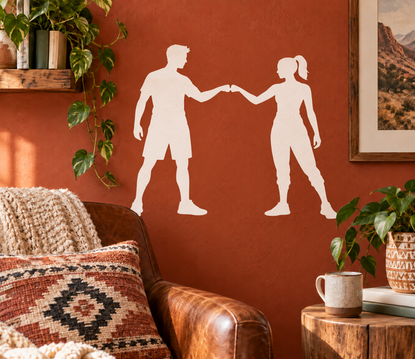 White vinyl decal of two parkour silhouettes holding hands on a wall