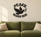 Peace vinyl decal with black dove, wings, and text “PEACE BEGINS HERE”