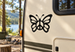 Black butterfly vinyl decal with peace symbol in the center on a camper