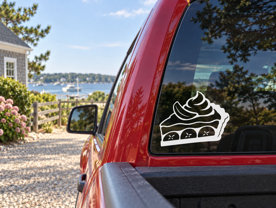 Banana cream pie slice vinyl decal with white outline and black fill, on car rear window