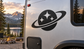 Black planet with three stars vinyl decal on a vehicle door