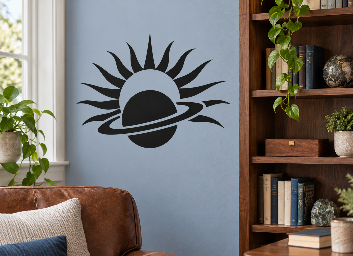 Black and white vinyl decal of a planet with sunburst rays, wall sticker design