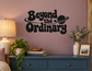 Black vinyl wall decal: 'Beyond the Ordinary' with planet icon