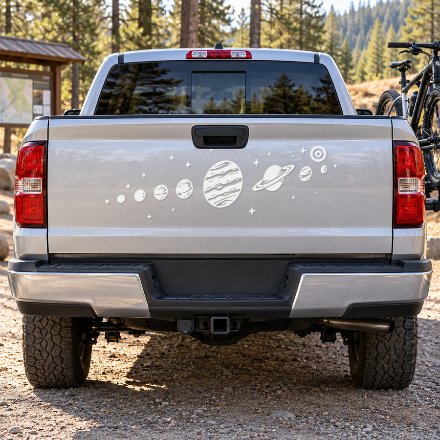 White truck tailgate with space planet and starburst decal graphic