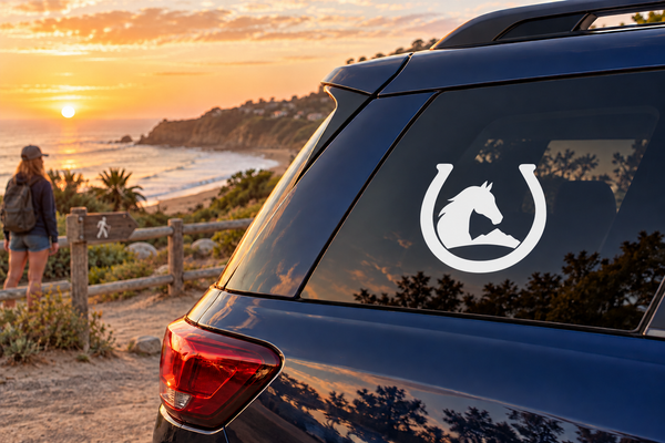 Vinyl decal with white horse in black horseshoe on a car rear window