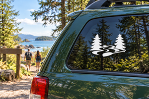 Vinyl decal with two pine trees and a white wavy river on a car window