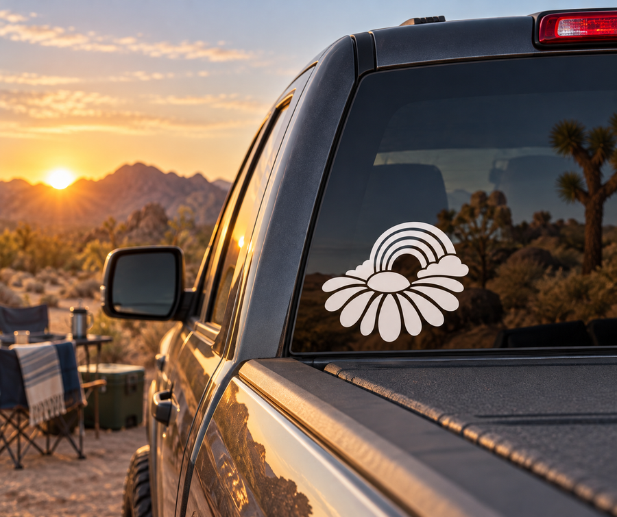 White daisy with rainbow vinyl decal on car window glass