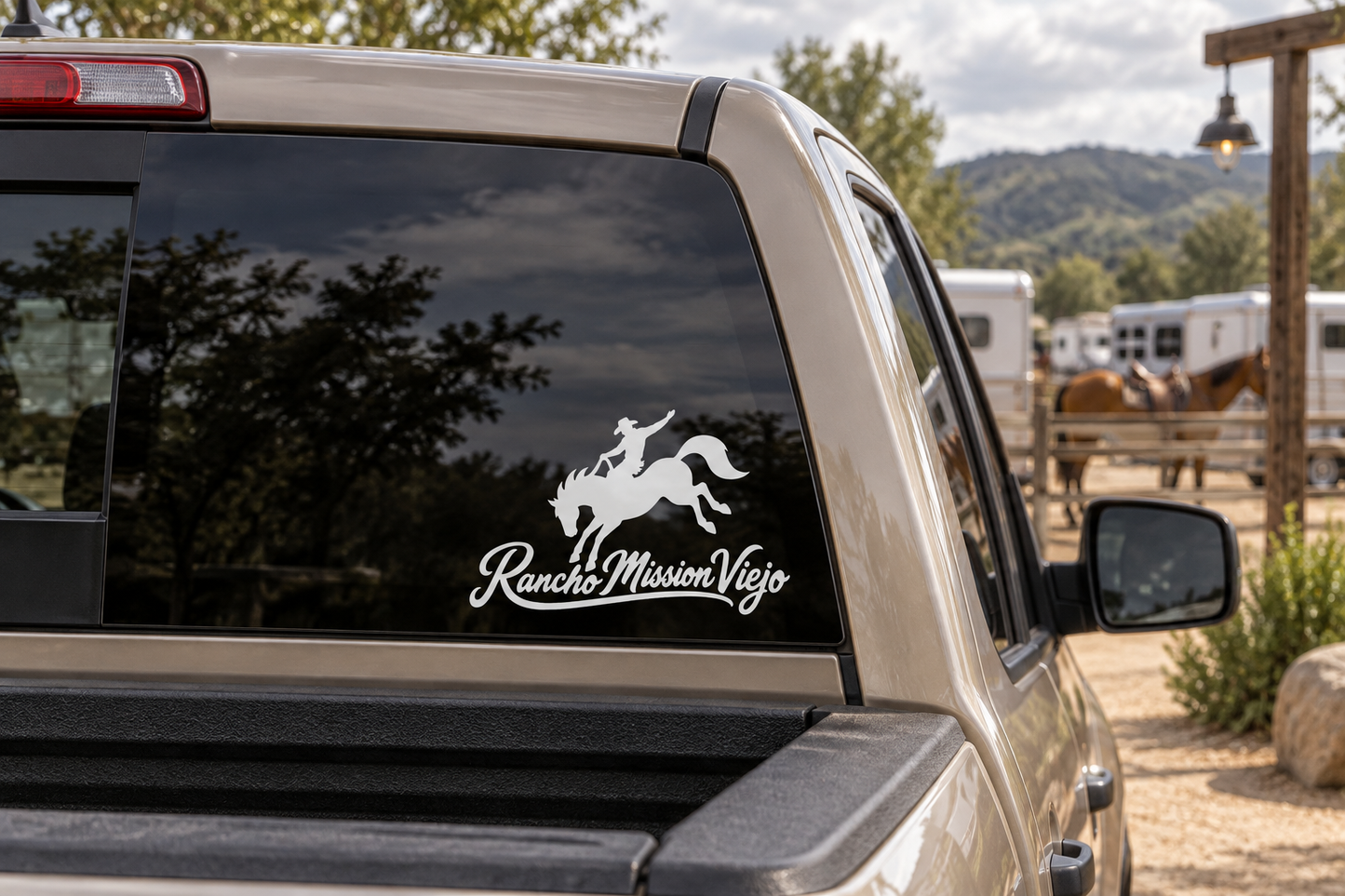 Car window vinyl decal: rider on horse silhouette with RanchoMissionViejo script