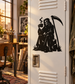Black grim reaper vinyl decal on white door, holding scythe and coffee cup with smoke