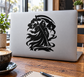 Black emblem vinyl decal featuring reaper with scythe, applied on laptop lid