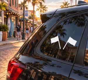 Pair of vinyl referee flag decals on a car window, two white flags on sticks