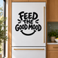 Vinyl decal: bold black 'FEED THE GOOD MOOD' smile graphic on a refrigerator door.