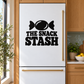 Black vinyl decal with 'THE SNACK STASH' text and candy icon on a refrigerator door.