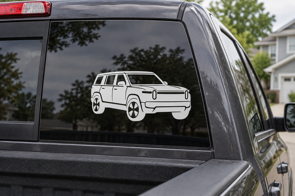 Rivian R1S front three-quarter vinyl decal, white car graphic on dark window glass.