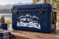 Rivian vinyl decal showing SUV, mountains, and trees in white on dark blue