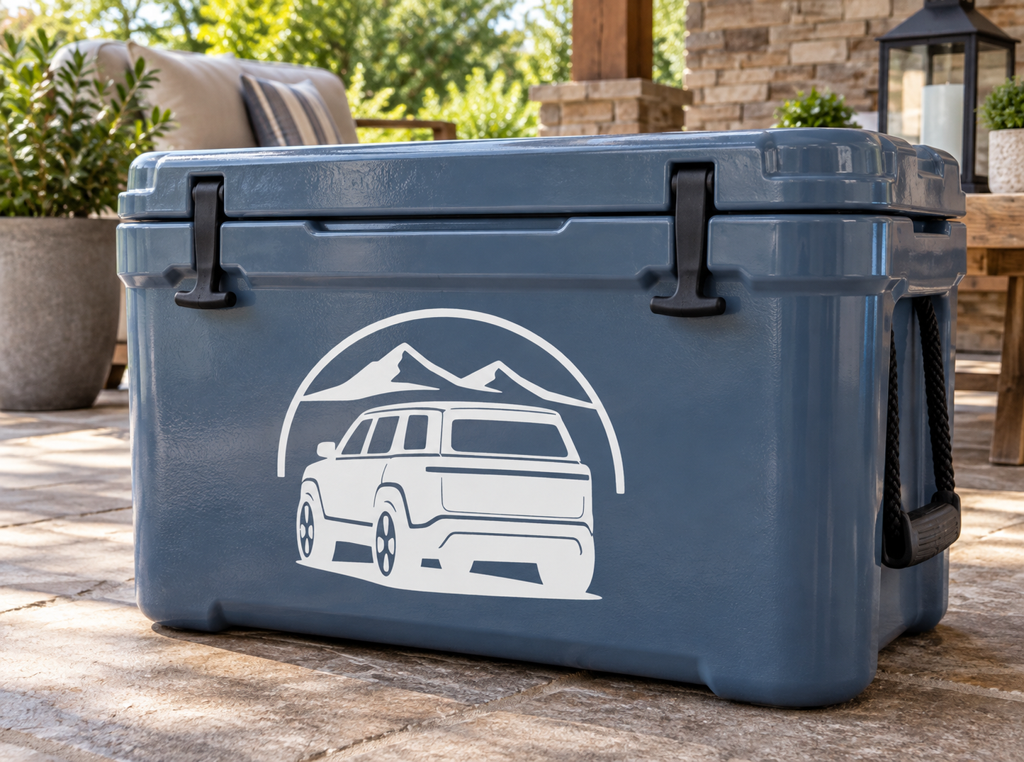 Vinyl vehicle decal in white with mountains and off-road SUV outline on blue surface