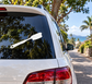 White climbing grip brush vinyl decal on car rear window glass