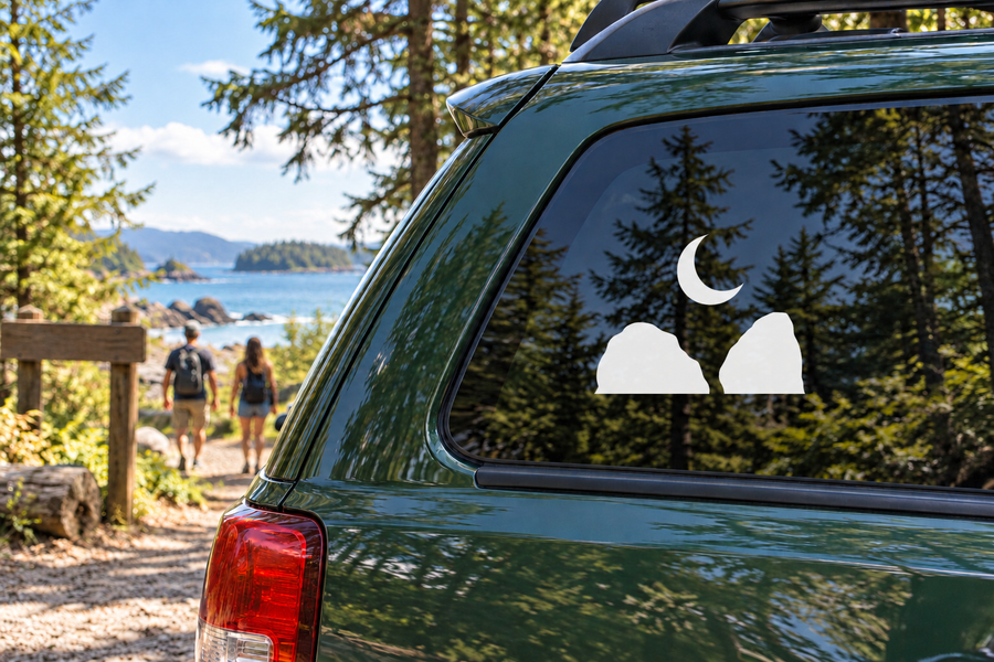 Rock climbing vinyl decal of a black crescent moon with two white boulder silhouettes