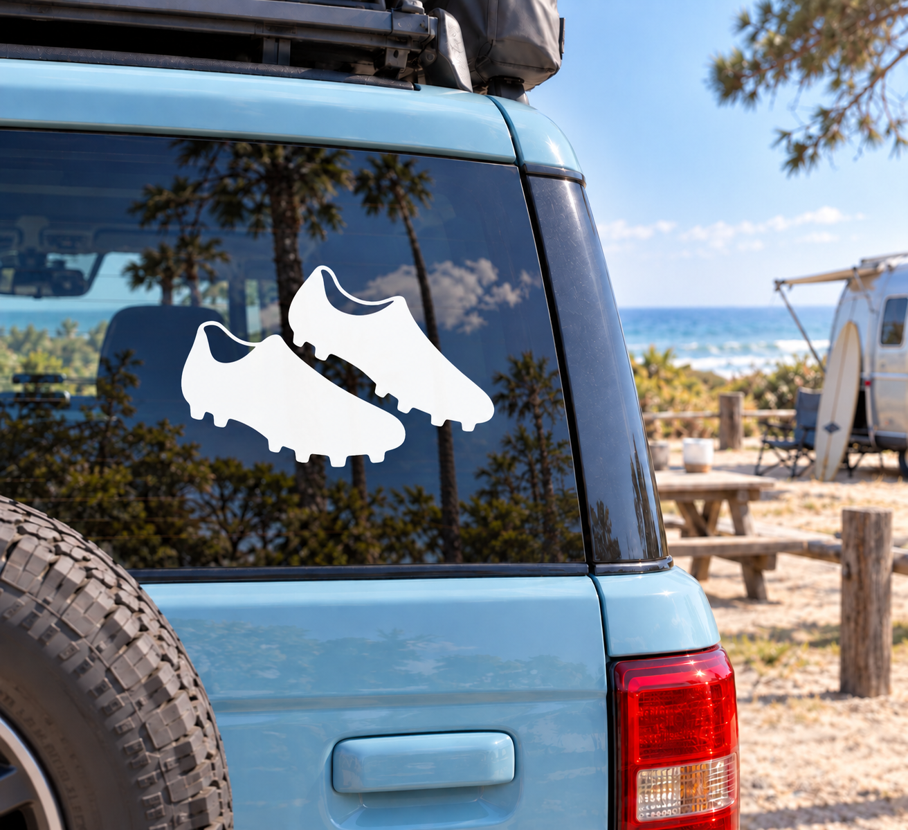 Pair of rugby boot vinyl decals, white boot shapes on car window