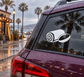 Vinyl decal with white swirl and oval rugby water-break icon on dark car window