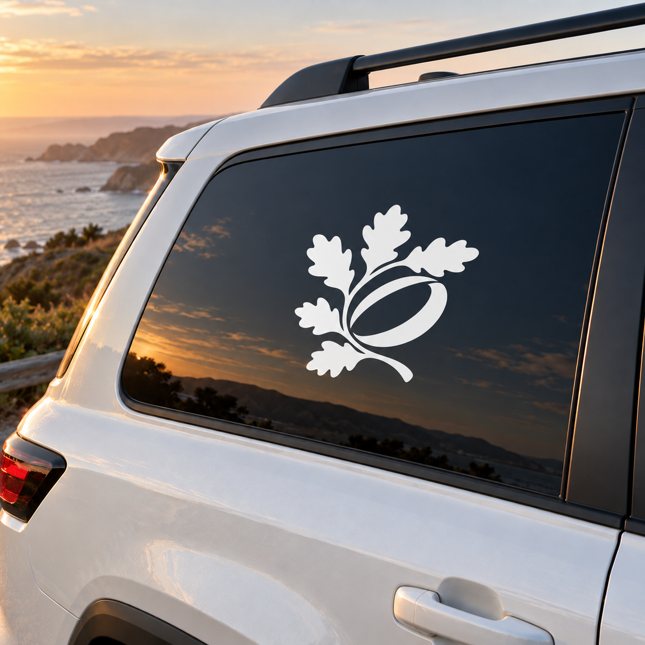 Vinyl decal of oak leaf emblem with acorn, white design on dark surface