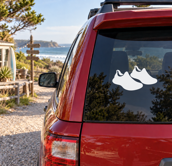 Pair of black running shoe silhouette vinyl decals on car window