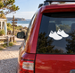 Pair of black running shoe silhouette vinyl decals on car window