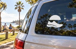 White running trail shoe vinyl decal on car rear window glass