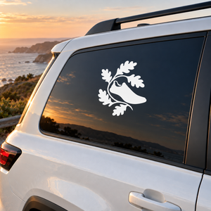 White vinyl decal of running animal with oak leaves on a dark car window panel